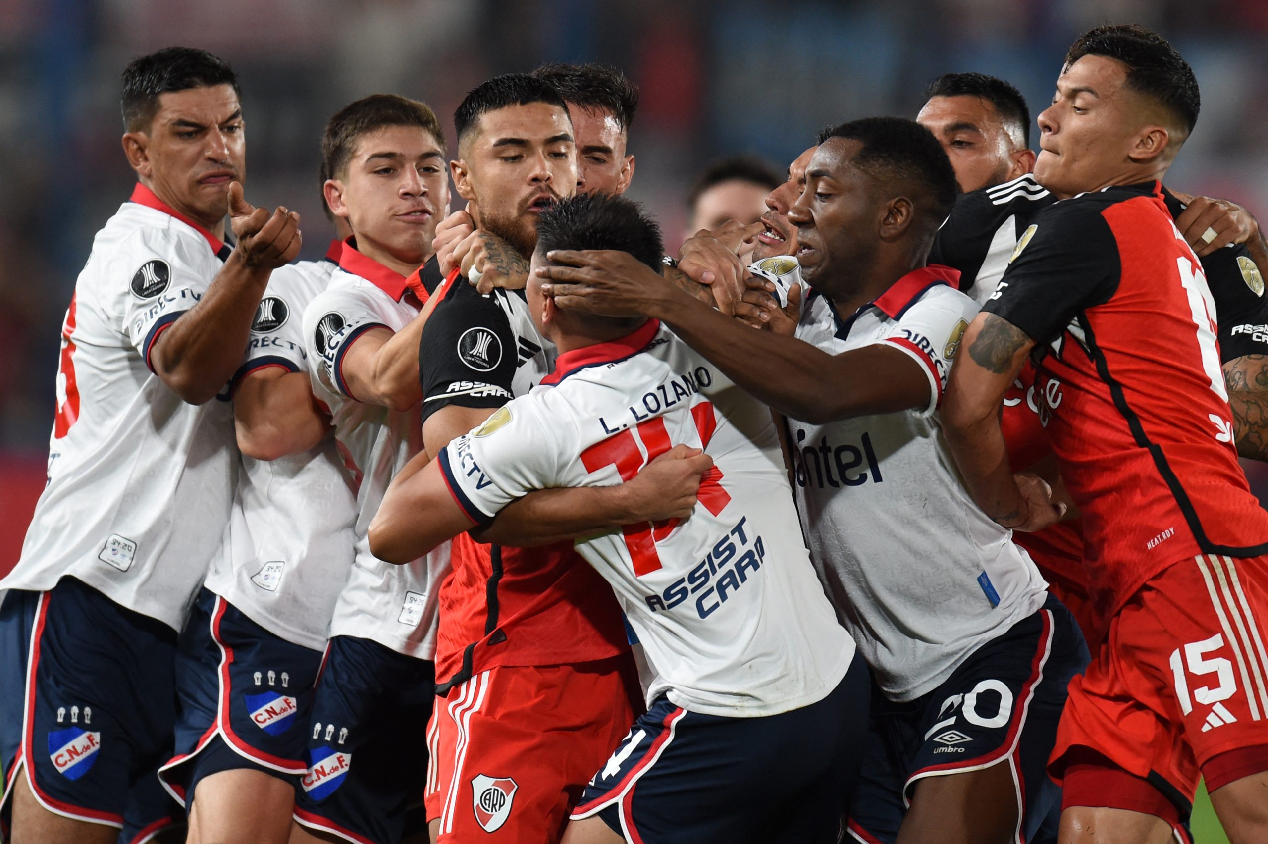 Players of Nacional and River Plate fight during the Copa Libertadores group stage second leg football match between Uruguay's Nacional and Argentina's River Plate at the Gran Parque Central stadium in Montevideo on May 7, 2024. (Photo by DANTE FERNANDEZ / AFP) (Photo by DANTE FERNANDEZ/AFP via Getty Images)