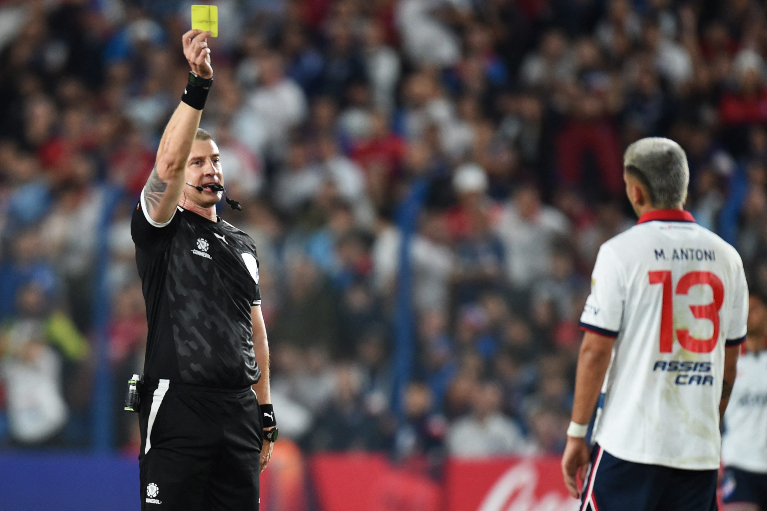 Brazilian referee Anderson Daronco shows the yellow card to Nacional's defender Mateo Antoni during the Copa Libertadores group stage second leg football match between Uruguay's Nacional and Argentina's River Plate at the Gran Parque Central stadium in Montevideo, on May 7, 2024. (Photo by DANTE FERNANDEZ / AFP) (Photo by DANTE FERNANDEZ/AFP via Getty Images)