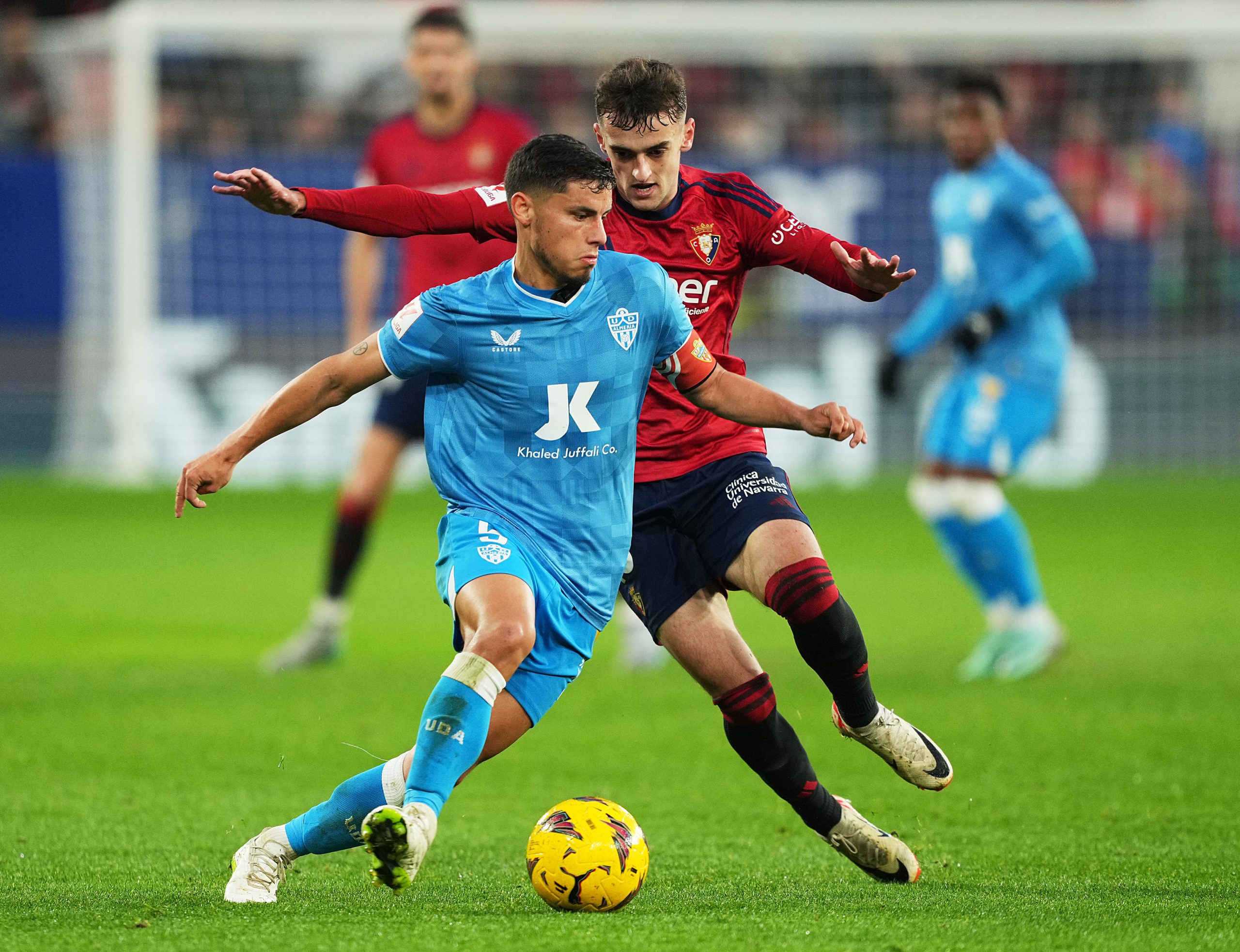 PAMPLONA, SPAIN - JANUARY 04: Lucas Robertone of UD Almeria runs with the ball whilst under pressure from David Garcia of CA Osasuna during the LaLiga EA Sports match between CA Osasuna and UD Almeria at Estadio El Sadar on January 04, 2024 in Pamplona, Spain. (Photo by Juan Manuel Serrano Arce/Getty Images)