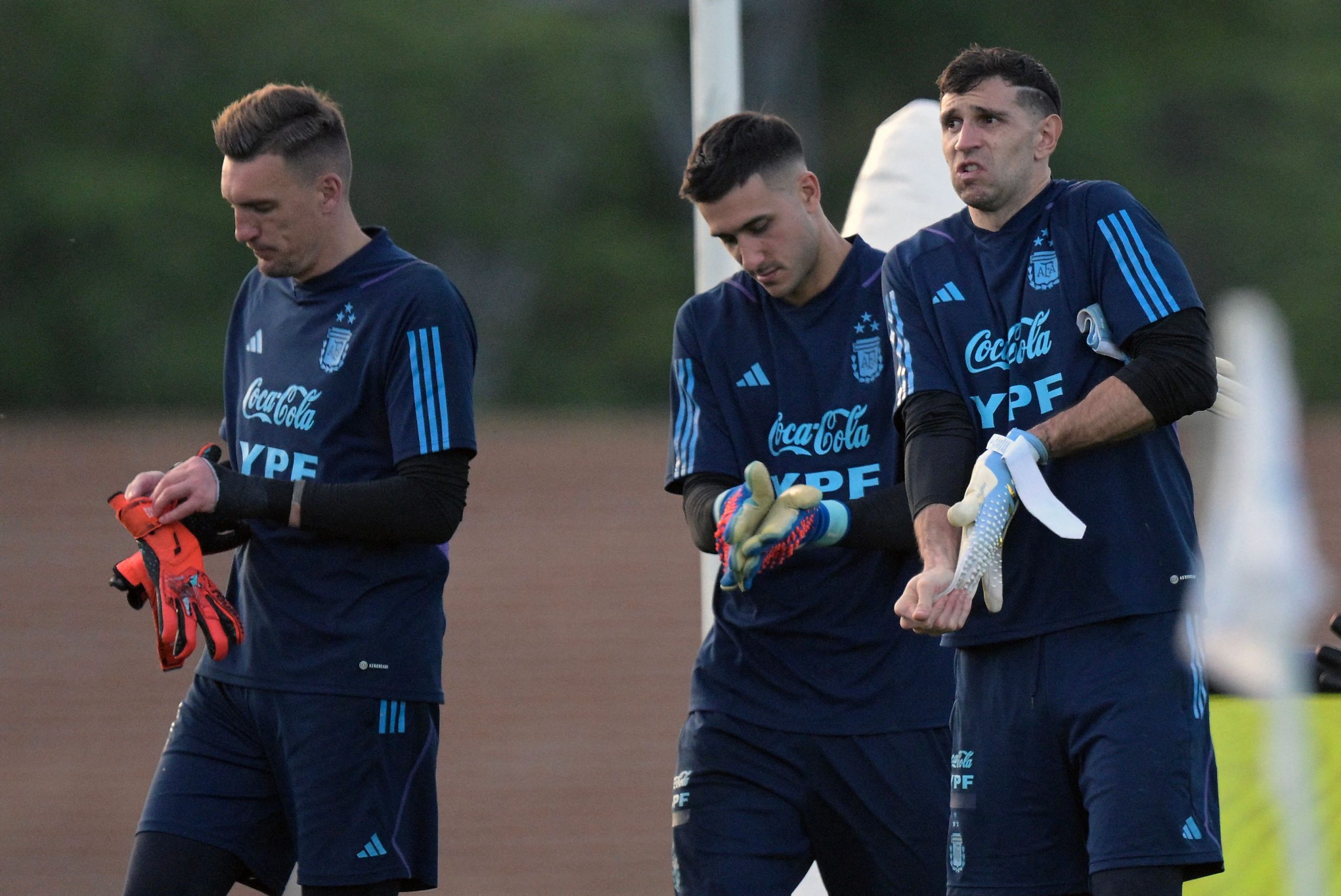 Argentina's goalkeepers (L-R) Franco Armani, Juan Musso and Emiliano Martinez gesture during a training session in Ezeiza, Buenos Aires on November 14, 2023, ahead of the FIFA World Cup 2026 qualifier football match against Uruguay on November 16 in Buenos Aires. (Photo by JUAN MABROMATA / AFP) (Photo by JUAN MABROMATA/AFP via Getty Images)